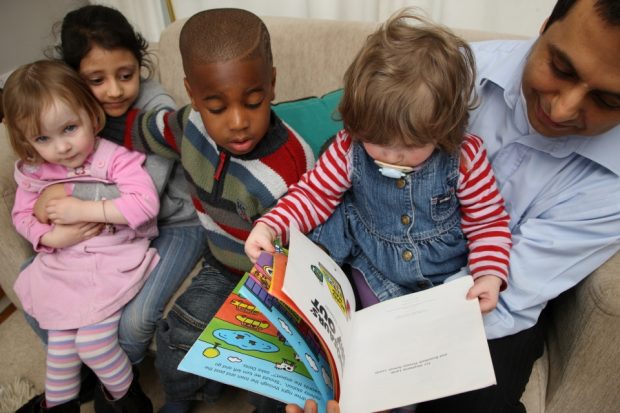Children on a sofa reading.