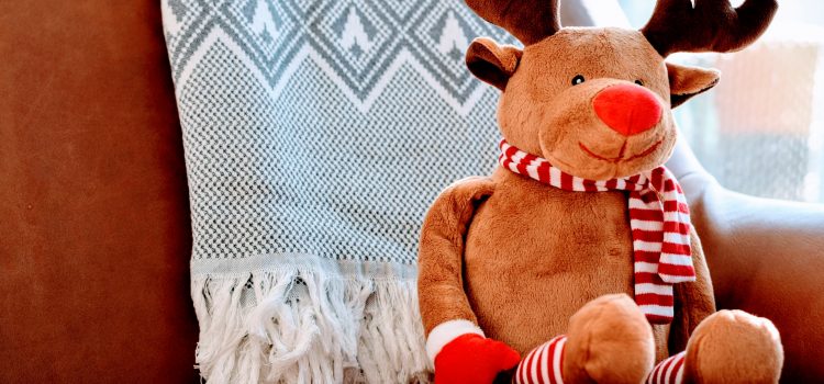 reindeer cuddly toy sat on a sofa