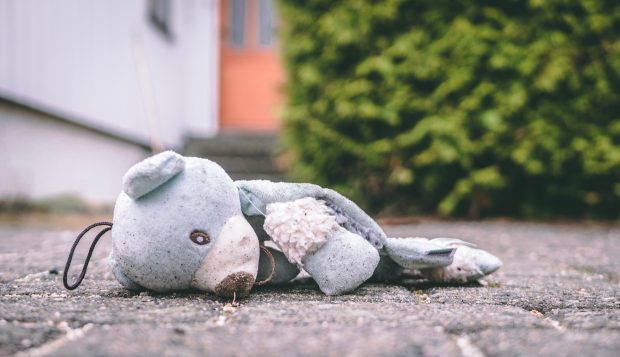 child's soft toy discarded on floor