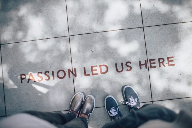 Picture of a pavement with the words 'passion lead us here' on it