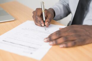 A man signing a form